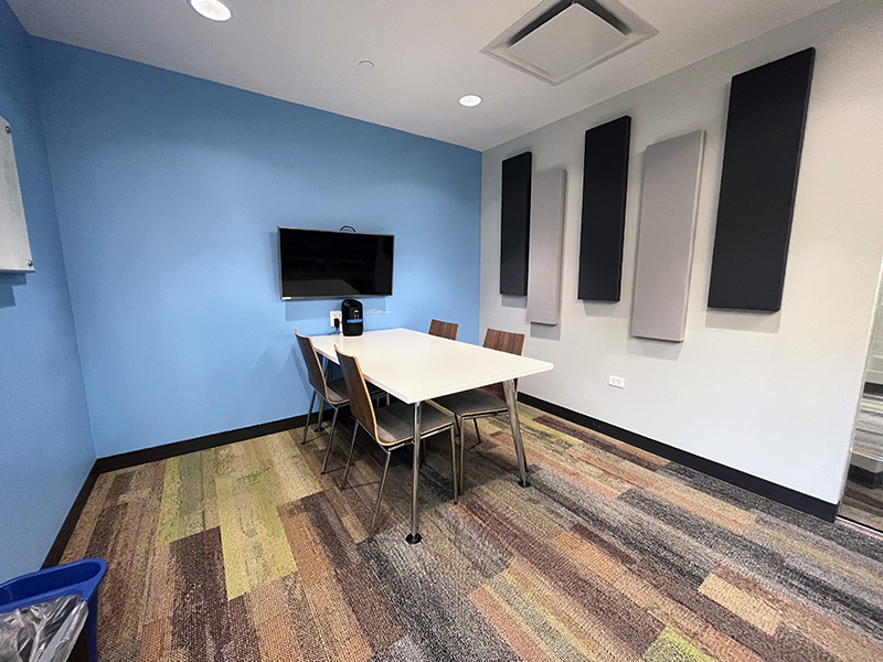 Study Room 1 with table, four chairs, and screen