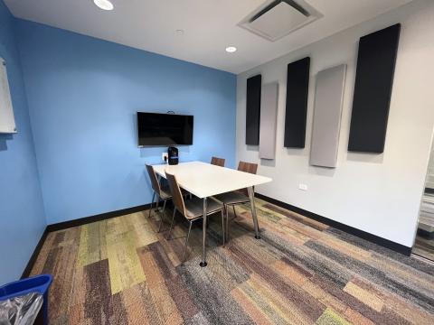 Small study room with display monitor and table and chairs