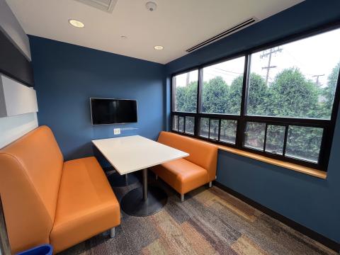 Study room with window, display monitor, table, and booth seating