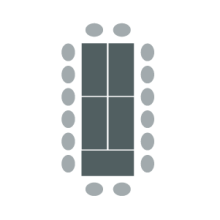 Figure of boardroom arrangement with several tables arranged in large rectangle with chairs around outside edge.